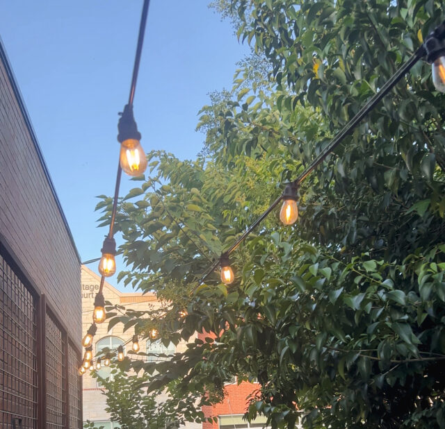 Outdoor string lighting to create a charming aesthetic for this small town business.