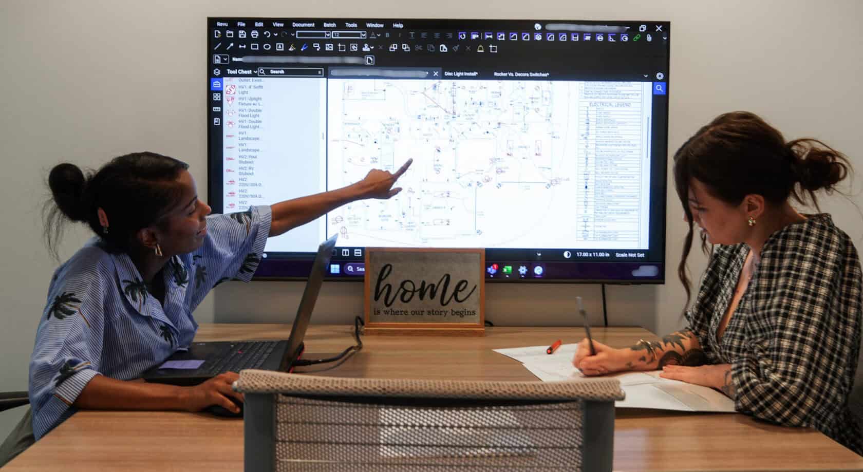 Electrical designer briefing homeowner about remodel project.