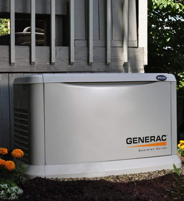 Generac generator installed next to deck.